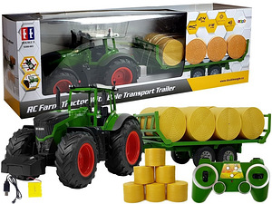 Сельскохозяйственный трактор rC с прицепом для перевозки тюков
