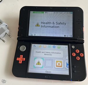 Новая Nintendo 3DS XL оранжево-черного цвета (1 фото из 3)